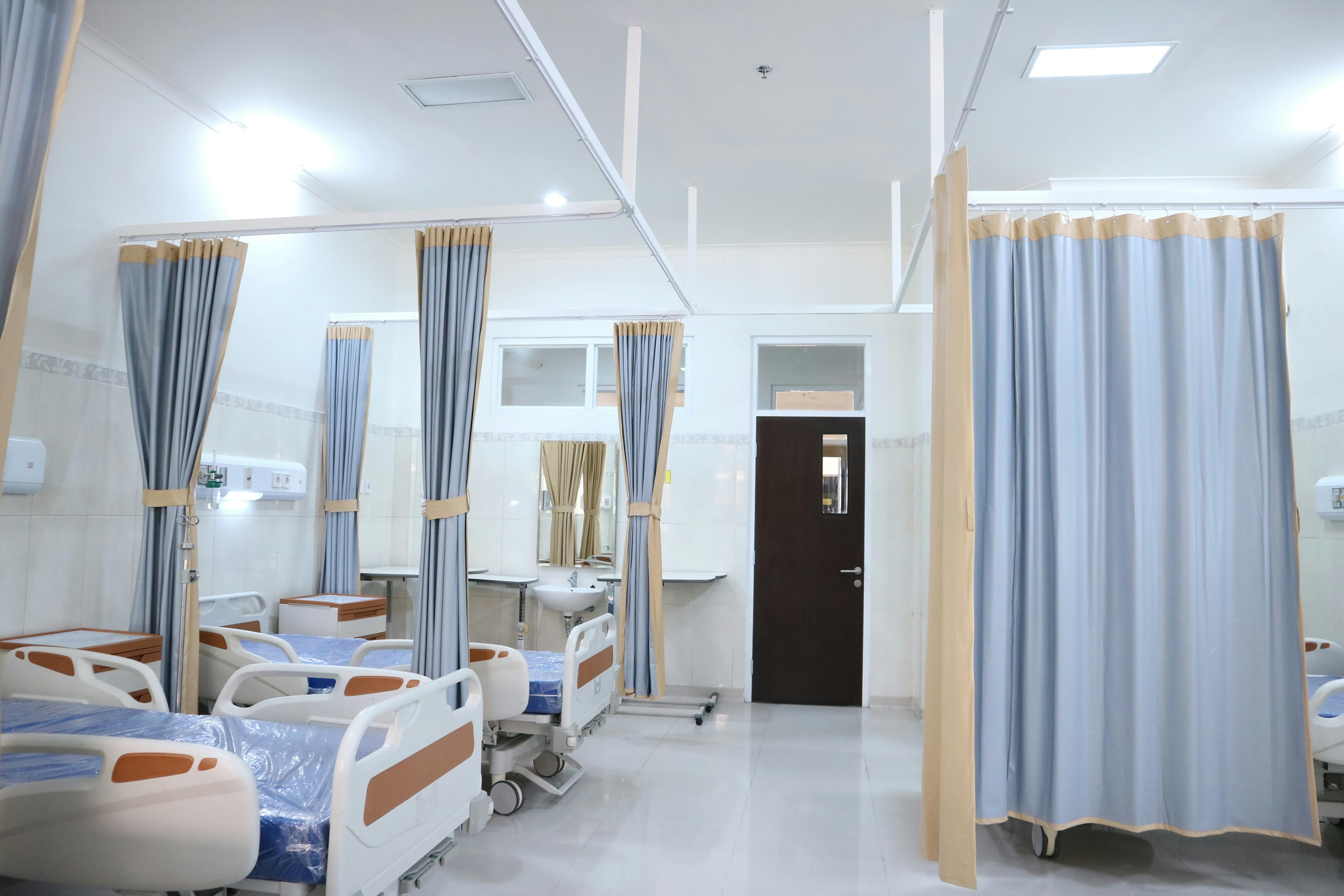 Hospital examination room with curtains.